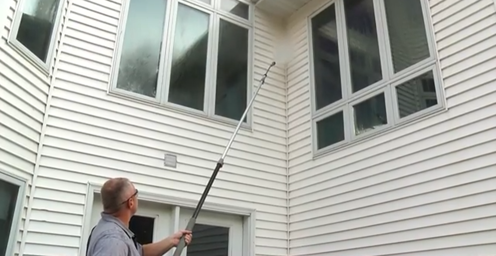 guy using a pressure washer accessory: the extension wand